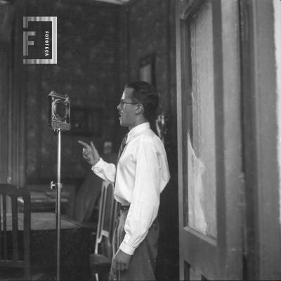 César C. Bustos (Pocholo) hablando en micrófono, c. 1933